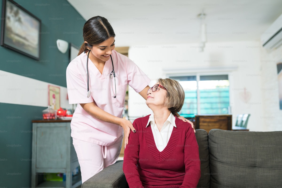Caregiver talking with smiling senior woman